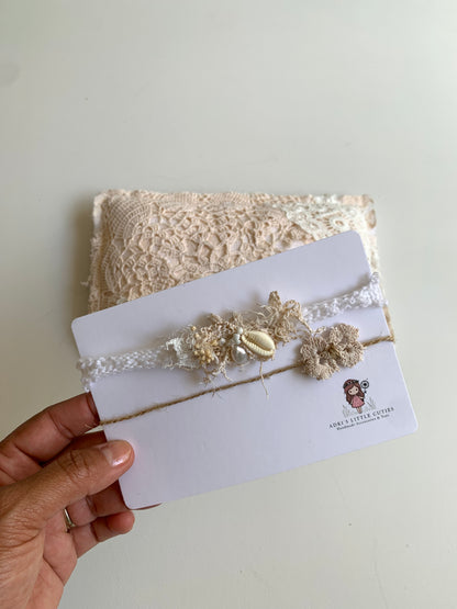 a person holding a card wshowing the baby headband set of 2
wo headbands designs to show size close to the matching pillow
