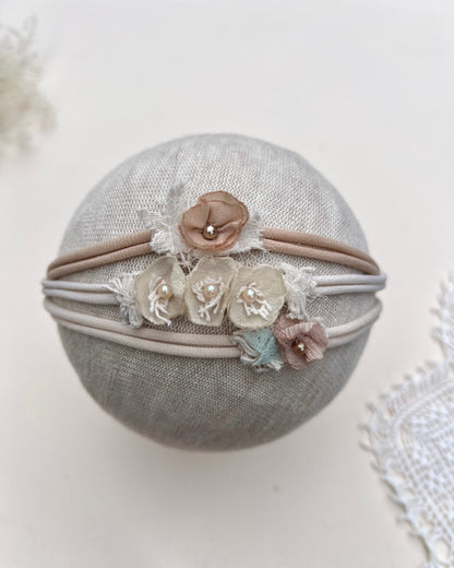 Set of floral headbands on a gray fabric ball with a white background