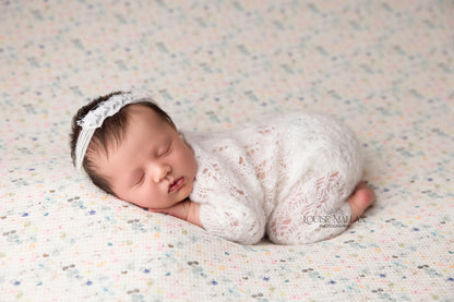 a newborn baby girl wearing the delicate star headband