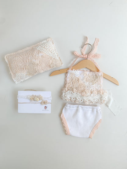 Newborn girl outfit for photoshoot session with matching pillow and headband in white and soft peach
