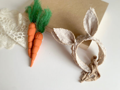 Bunny ears with felt carrots on a white background